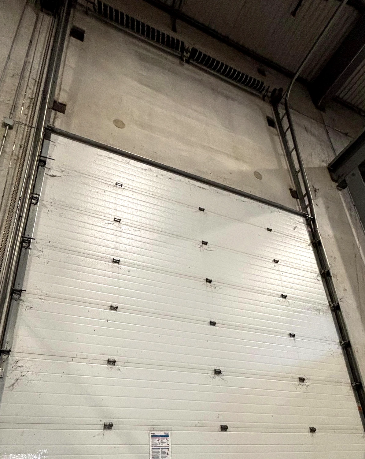 Commercial overhead garage door photographed on a real Swift Garage Doors job