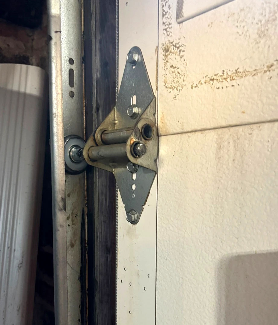Garage door hinge roller and track detail from a real service call