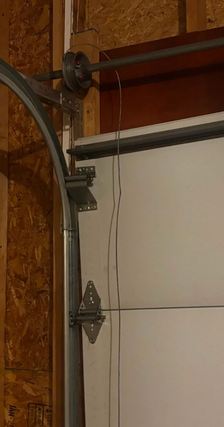 Snapped garage door cables tangled near the track during a repair in Park Ridge, Illinois