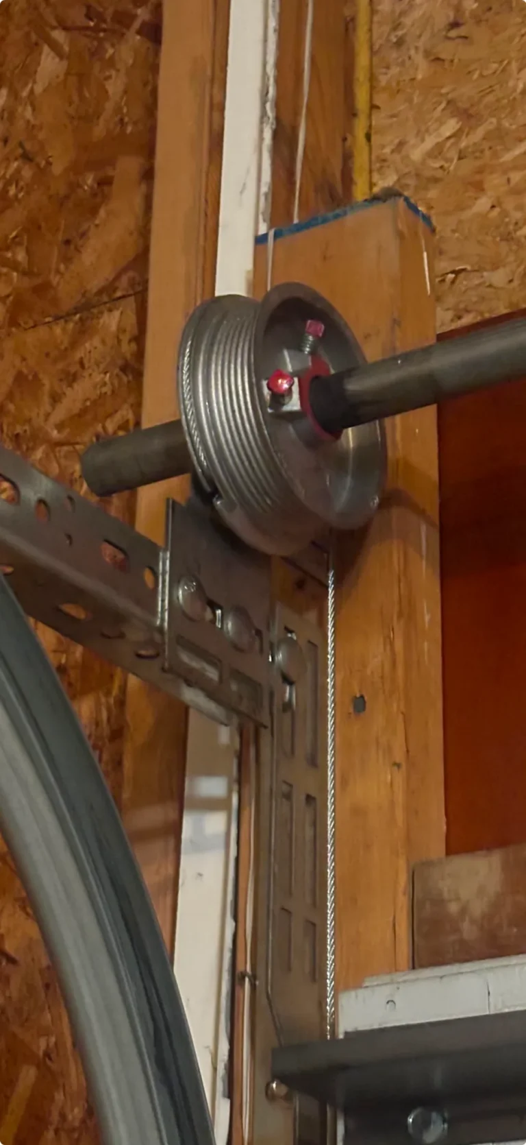 Garage door cable, drum and pulley hardware during a repair in Park Ridge, Illinois